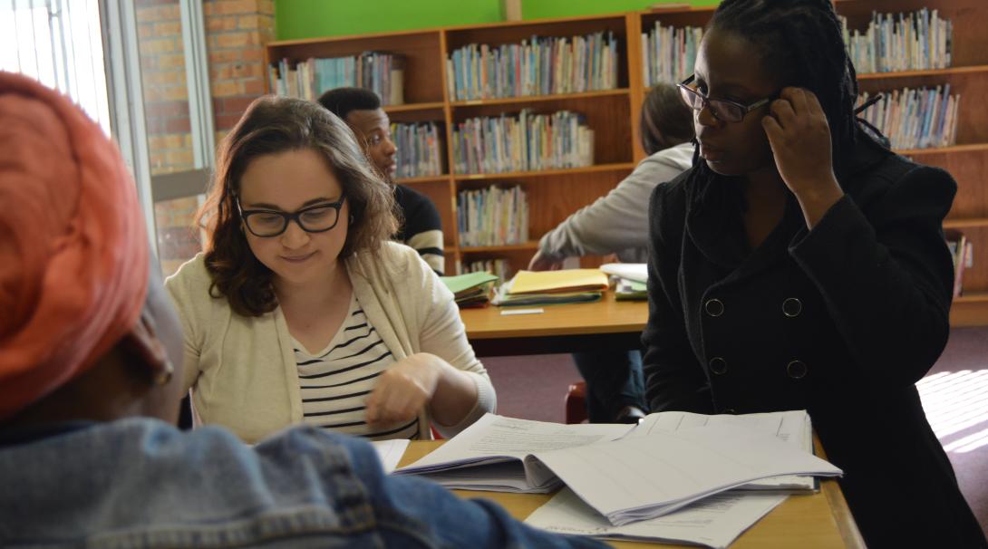 A Projects Abroad lawyer guides a student interning overseas through a consultation with a client. An intern abroad participates in a legal clinic with the help of a lawyer in Cape Town, South Africa.